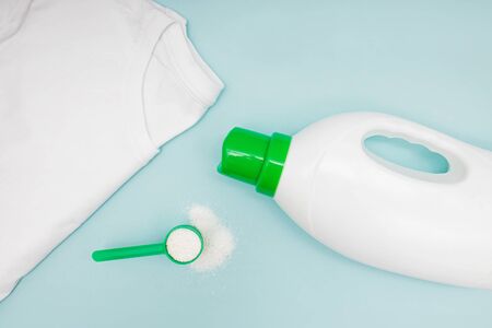 Natural washing liquid and powder and clean t-shirt on blue background. Laundry composition, top viewの写真素材