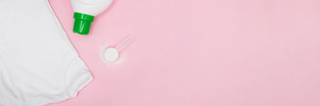 Clean white t-shitr, powder washing detergent and plastic bottle of liquid on pink background