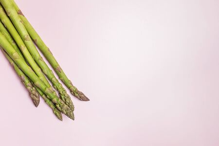 Green seasonal asparagus on a pink background, on a colored background asparagusの写真素材