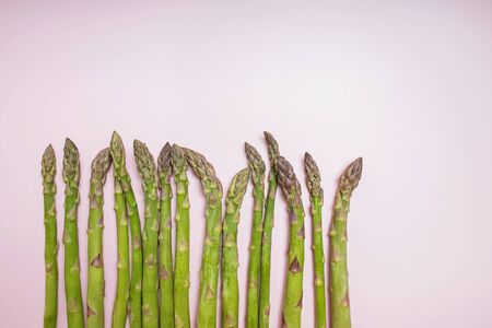 Fresh green asparagus on a pink background with copy spaceの写真素材