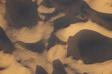 Beach sand in natural sunset light.