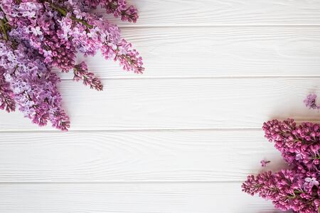 The beautiful lilac flowers on a white wooden backgroundの写真素材