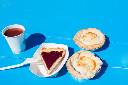 Different pies on blue table on sunny day. Summer picnicの写真素材