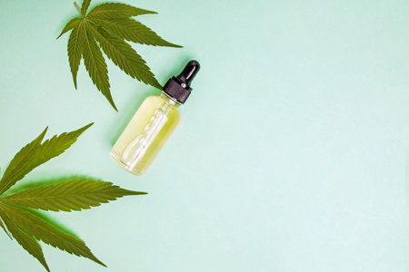 Bottle of oil or hemp extract and cannabis leaves