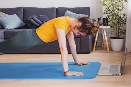 Young woman doing yoga at living room
