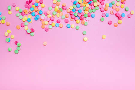Decorative sugar sprinkles on a pink backdrop.の写真素材