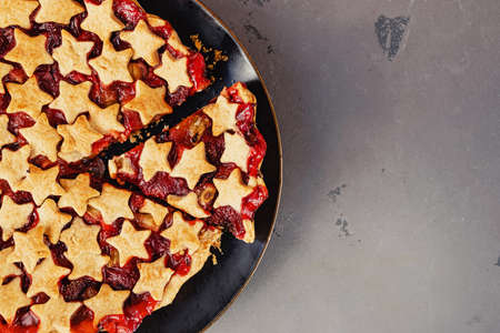 Strawberry and rhubarb pie decorated with stars on white table, top viewの写真素材