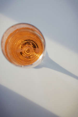 Glass with rose sparkling wine on the white table withの写真素材