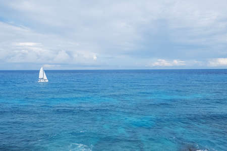 A lonely sailing boat in the seaの写真素材