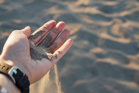 Sand is falling from girls palm