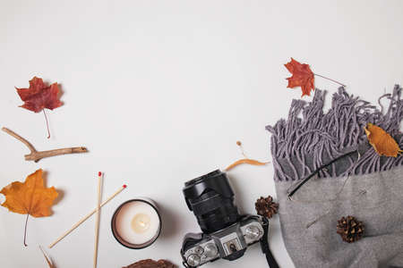 Scarf, camera, candle and yellow leaves, top viewの写真素材