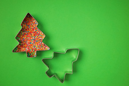 Christmas tree shape form and scattering multicolored confectioneryの写真素材