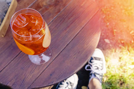 A glass of cold alcoholic drink with fruit slices and ice cubesの写真素材