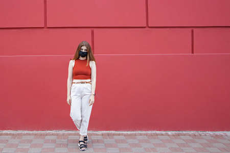 Portrait of an attractive young caucasian woman in a protective medical maskの写真素材