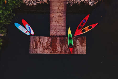 Aerial view of kayaks and paddle boards near a wooden boat pierの写真素材