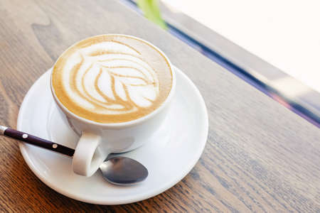 Close-up of hot cappuccino coffee dressing with leave shape of latte artの写真素材