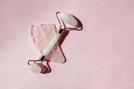 Face massage accessories on pink backgroundの写真素材