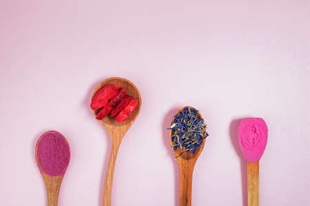 Dry confectionery ingredients in wooden spoons.の写真素材