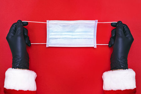 Santa Claus is going to wear protective medical mask.