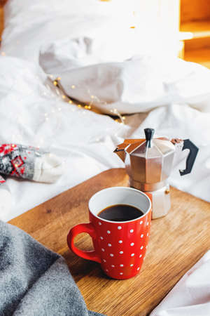 Cup of coffee and coffee maker on wooden traの写真素材