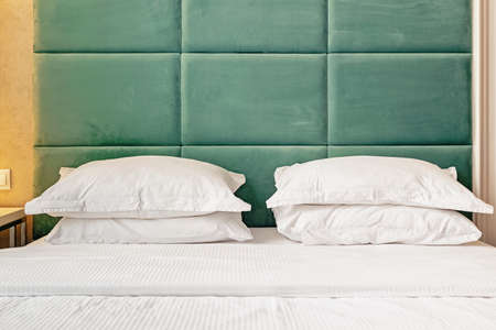 Comfort stylish bed in bedroom or hotel roomの写真素材