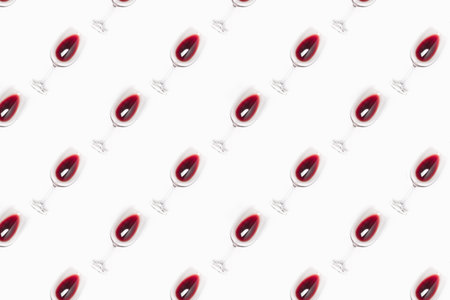 Seamless pattern made of wine glasses filled with red wine