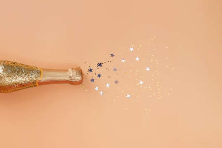 Bottle of champagne decorated with golden glitterの写真素材