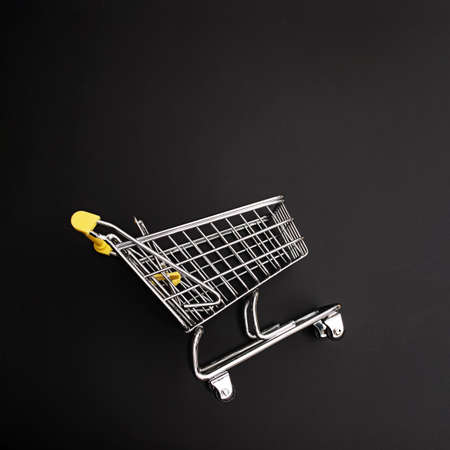 Mini shopping cart on black backgroundの写真素材