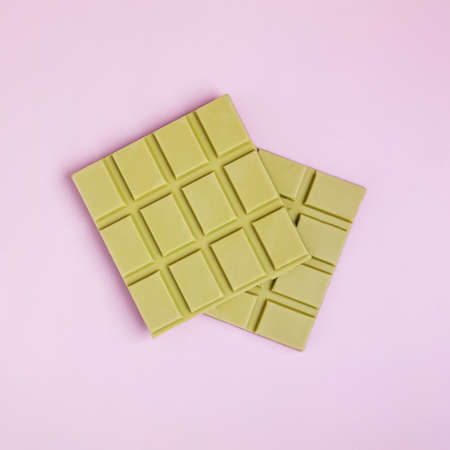 Square bars of milk chocolate of green colorの写真素材