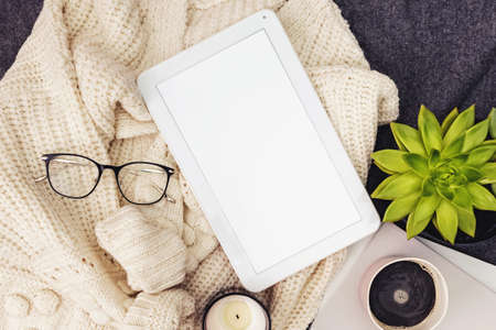 Tablet mock-up in lifestyle composition. Sweater, coffee, candle and glassesの写真素材