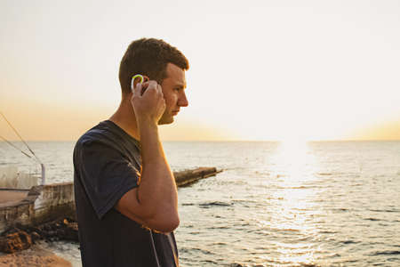 Man preparing for jogging near the sea at the morning.の写真素材