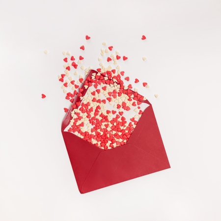 Sugar heat shaped sprinkles fly out of red envelope