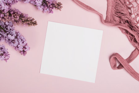 Blank paper mock-up and lilac flowers on pink bacgkround.の写真素材