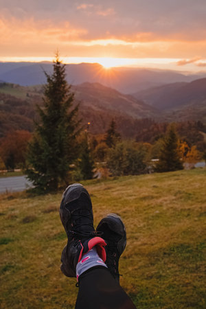 Womans feet on the background of mountains at sunset
