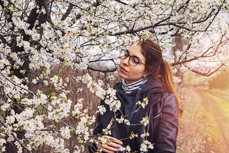 Woman enjoying spring blooming trees