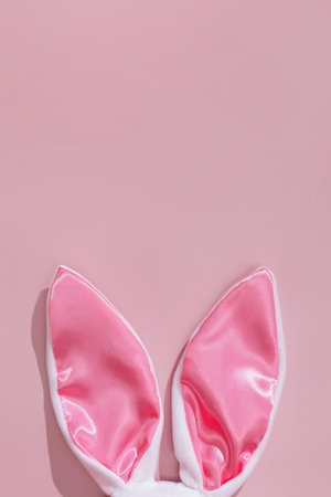Decorative bunny ears on pink background.