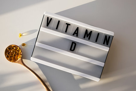 Capsules with vitamin D in wooden spoonの写真素材