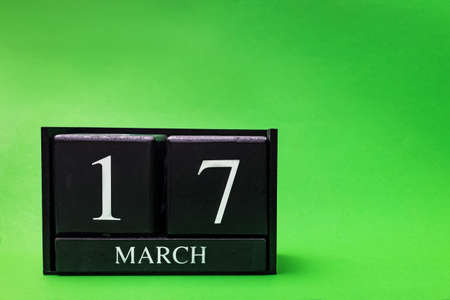 Block calendar for March 17 St Patricks Day on green backgroundの写真素材