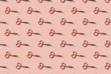 Cosmetic scissors on pink background.の写真素材