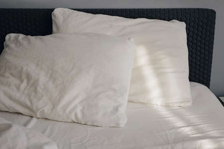 Close-up of white pillows with morning light.の写真素材