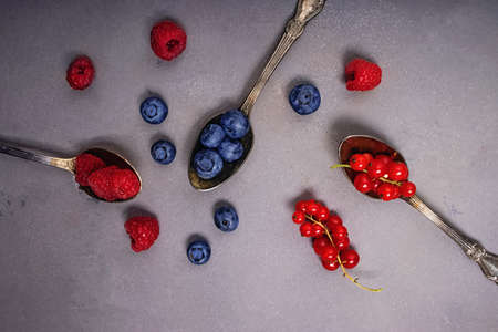 Different types of berries in the spoons.の写真素材