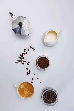 Still life with moka pot, coffee beans and fresh hot espresso in a cupの写真素材
