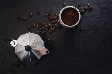 Still life with moka pot and coffee beans on black stone backgroundの写真素材