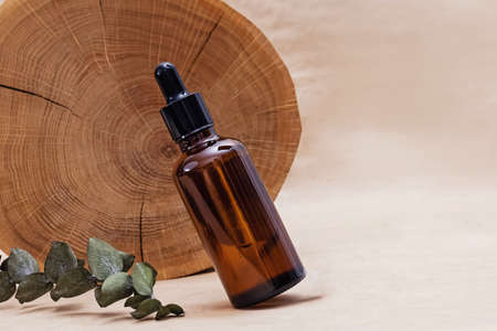 Bottle with face serum and wooden saw cutの写真素材