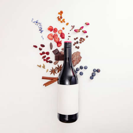 Composition with wine bottle and possible flavor components of red wineの写真素材