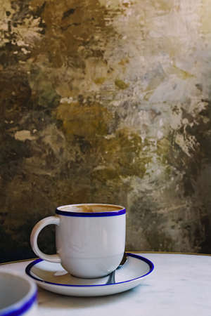Cup of coffee over the grunge stone wallの写真素材