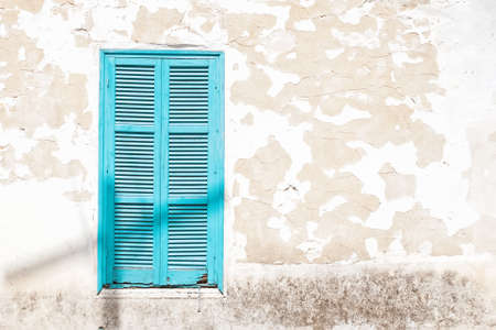 Wooden Turquoise window shutters on a grunge wallの写真素材