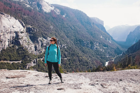 Young woman hiker standing with a view.