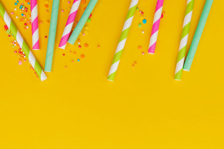 Multicolored party drinking straws and sugar sprinkles