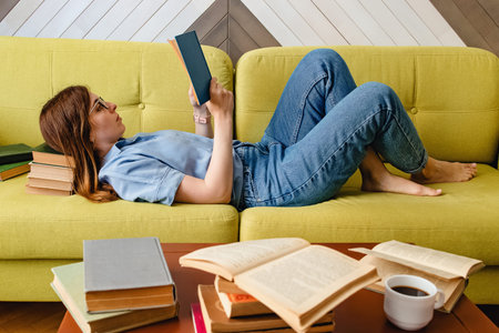 Young woman reading on the sofa at the living room